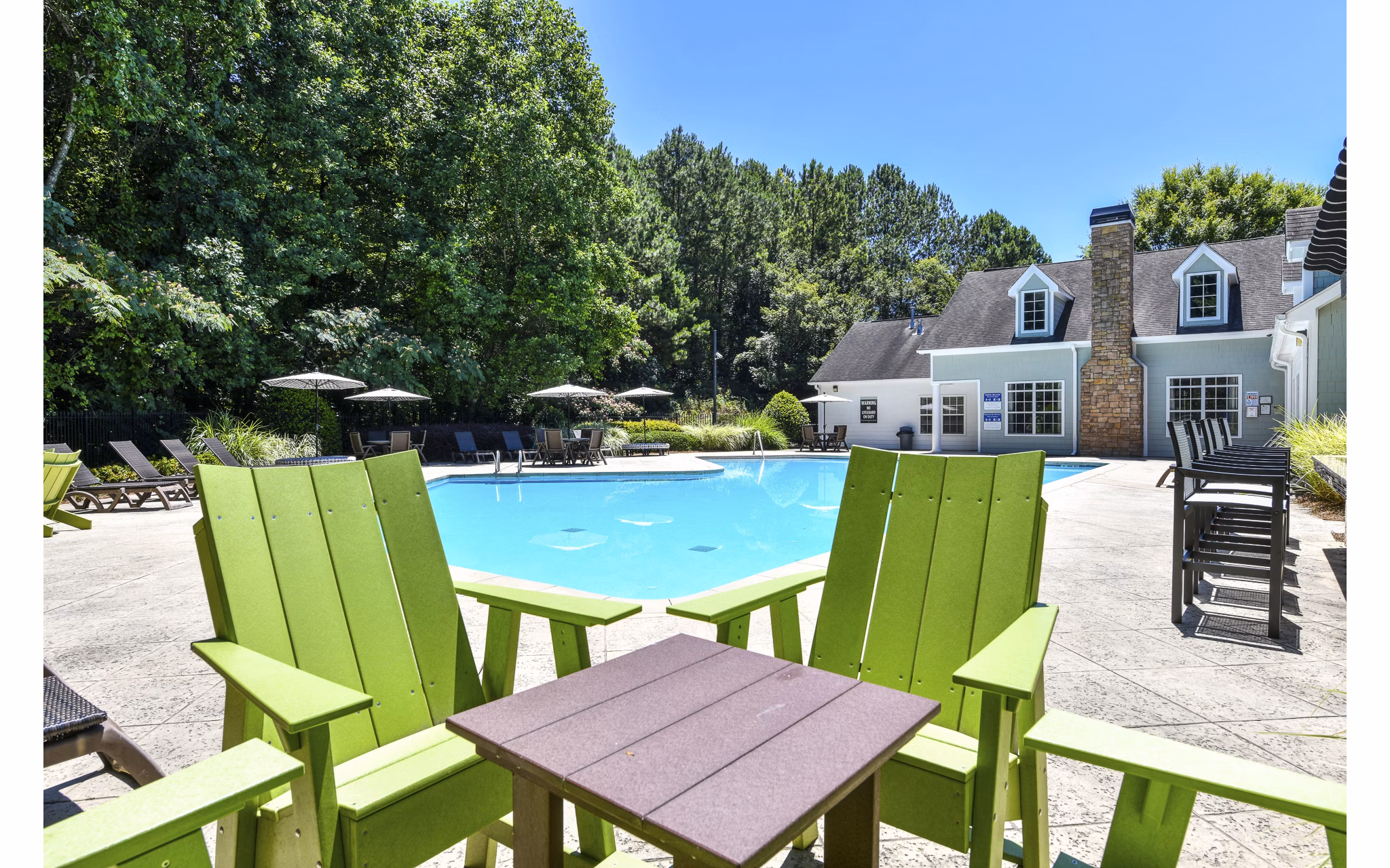 Relaxing pool area with sun loungers at Avana Twenty9 Apartments luxury apartments