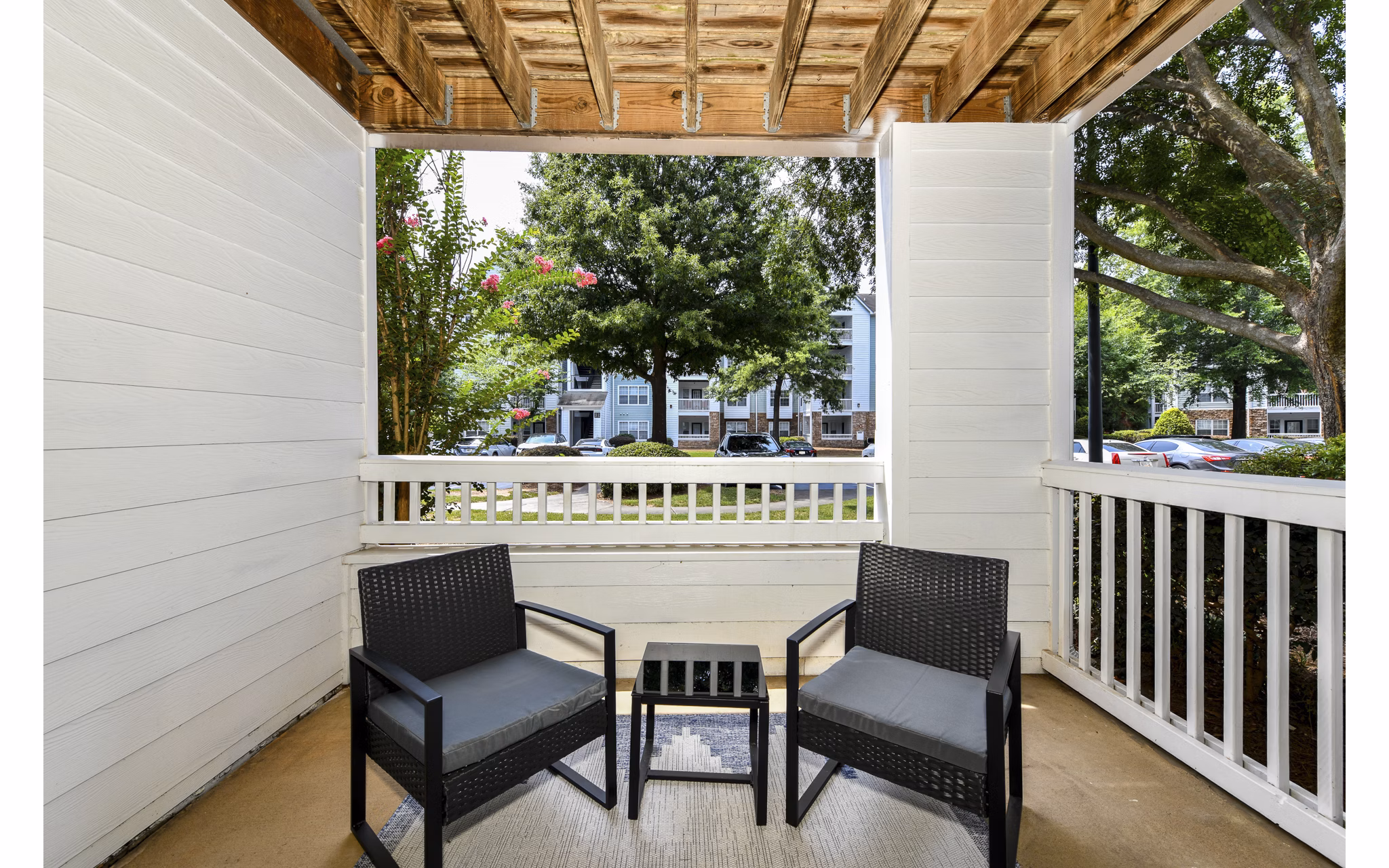 Patio at Avana Twenty9 Apartments: Outdoor seating area with garden views in Greystar luxury apartments