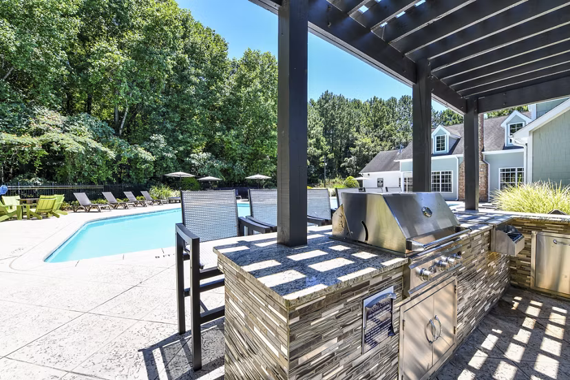 Outdoor grill area with modern seating at Avana Twenty9 Apartments