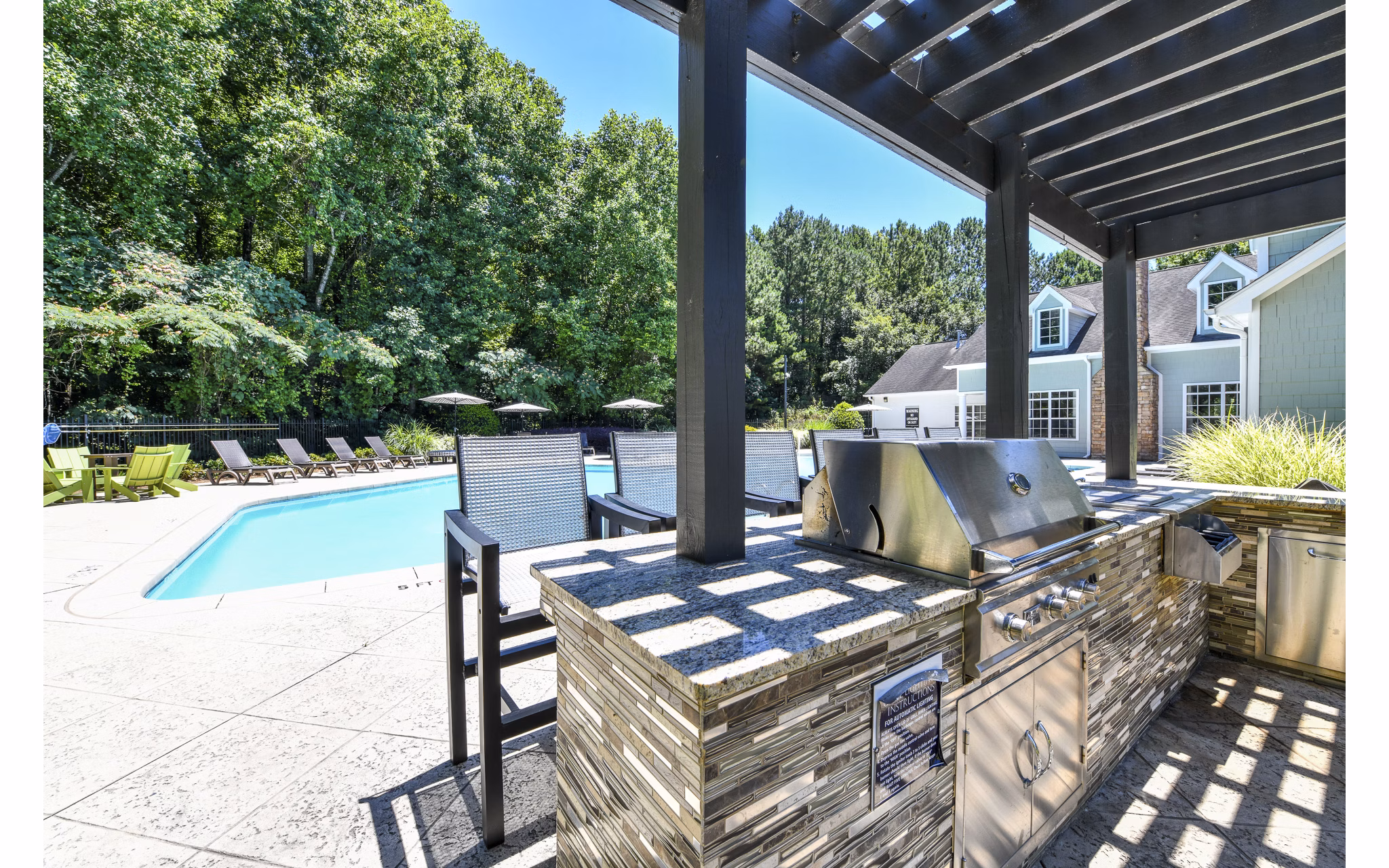 Outdoor grill area with modern seating at Avana Twenty9 Apartments
