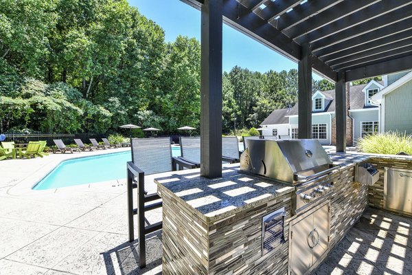 Outdoor grill area with modern seating at Avana Twenty9 Apartments