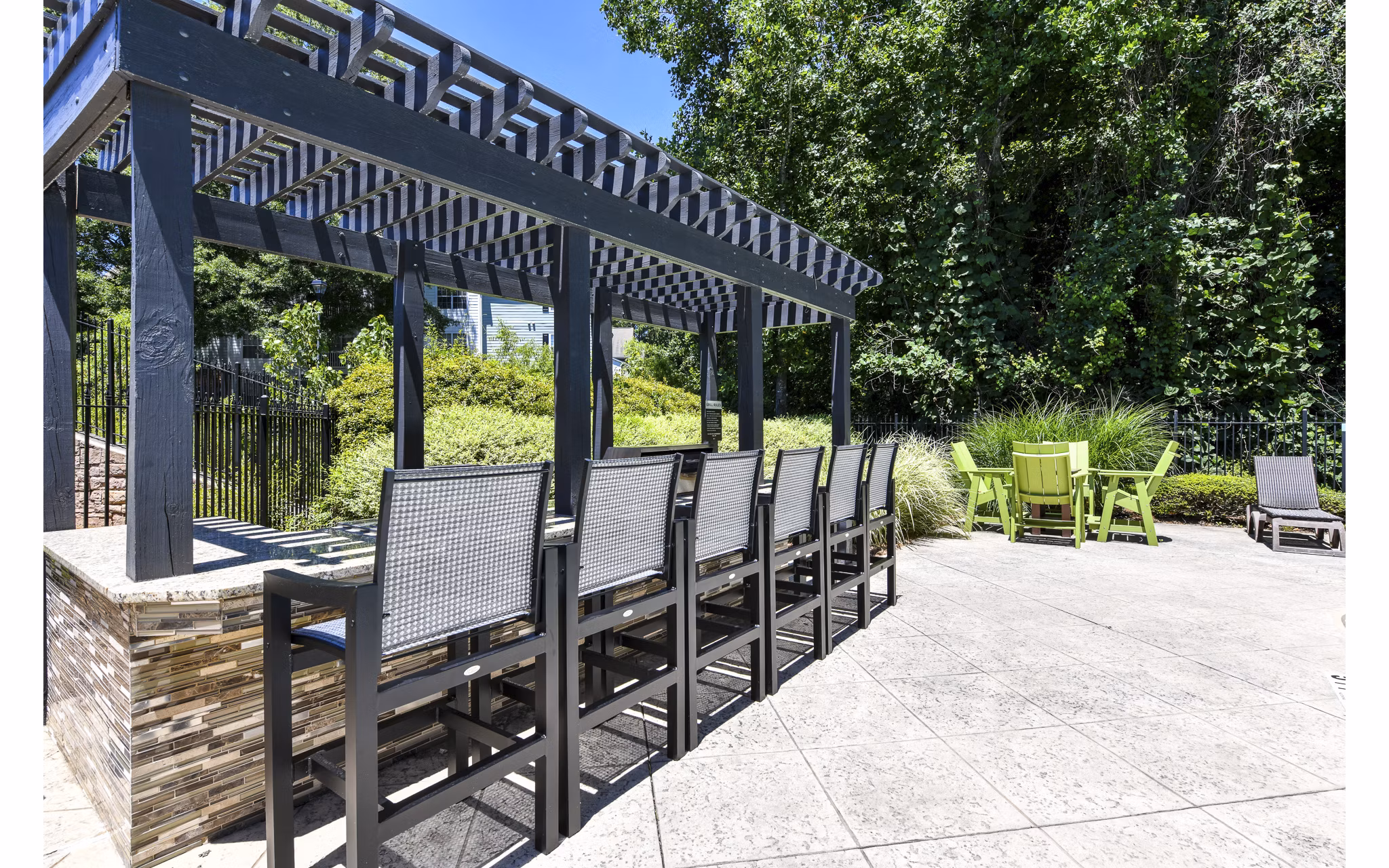 Tranquil garden courtyard with seating area at Avana Twenty9 Apartments