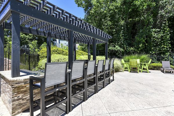 Tranquil garden courtyard with seating area at Avana Twenty9 Apartments
