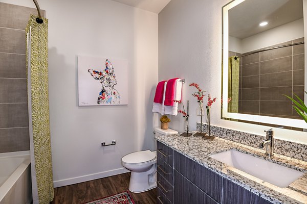 Kestra Apartments: Modern bathroom with a walk-in shower and marble countertops