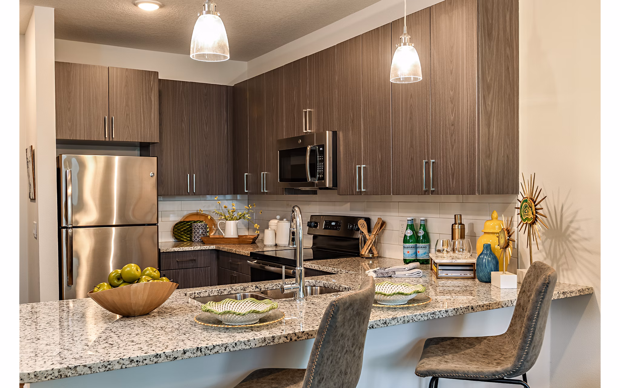 Modern kitchen featuring stainless steel appliances and quartz countertops at Kestra Apartments