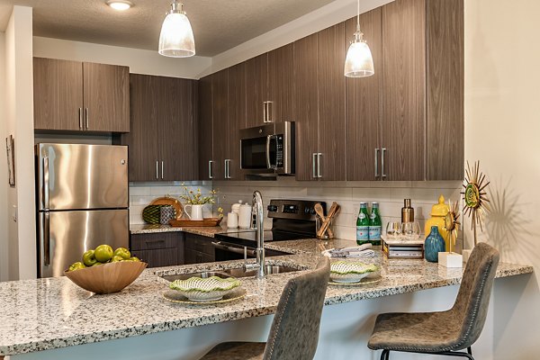 Modern kitchen featuring stainless steel appliances and quartz countertops at Kestra Apartments