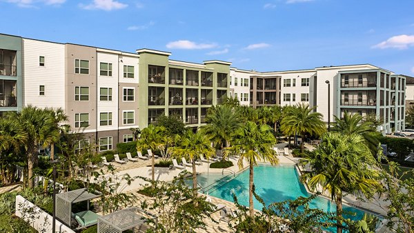 Kestra Apartments: Elegant pool area with lush surroundings offering a relaxing retreat in a luxury apartment community