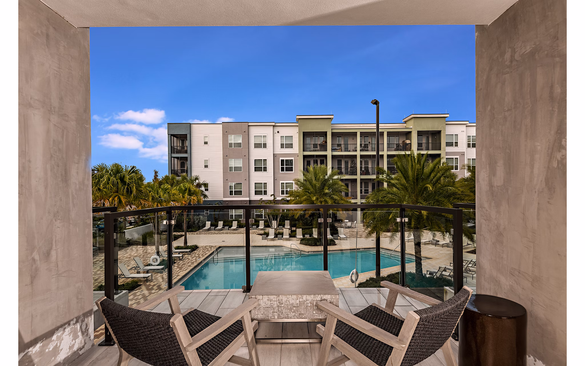 Sleek pool area with modern lounge chairs at Kestra Apartments offering luxury outdoor relaxation