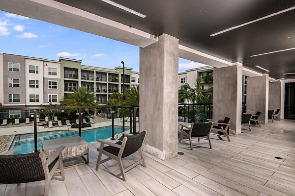 Resort-style pool area with lounge seating at Kestra Apartments, a luxury living space