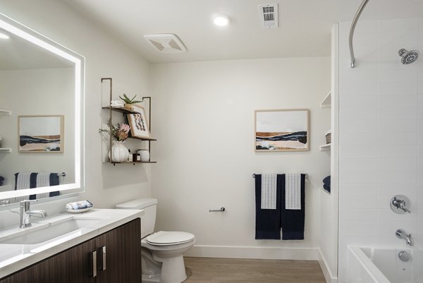Bathroom featuring sleek marble countertops and modern fixtures at Coastline Ventura Apartments