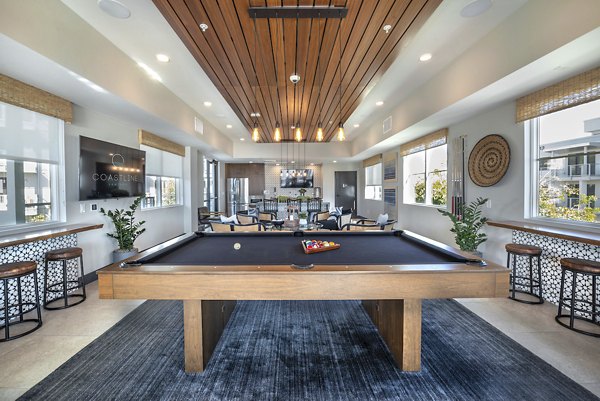 Game room with pool tables and arcade games at Coastline Ventura Apartments