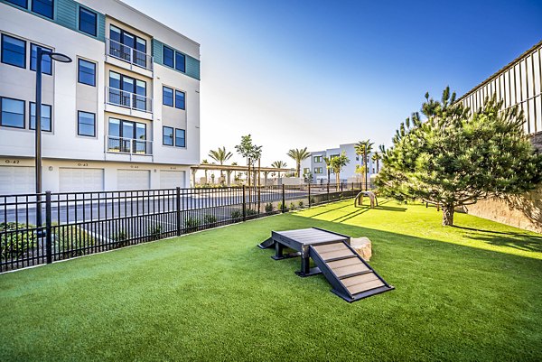 Modern playground with slides and climbing structures at Coastline Ventura Apartments, offering recreational fun for residents