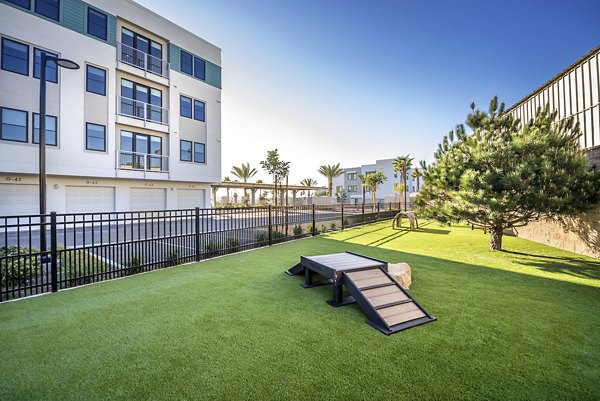Dog park with agility equipment at Coastline Ventura Apartments, offering pet-friendly amenities for residents and their furry friends