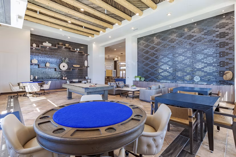 Game room with billiards and lounge seating at Overture Andalucia Apartments