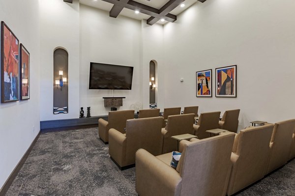 Overture Andalucia Apartments: Luxurious theater room with plush seating and ambient lighting for an elevated cinematic experience