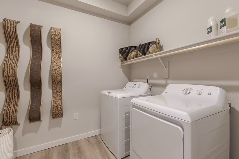 Laundry room with modern appliances in Overture Andalucia Apartments, ideal for a convenient living experience in a luxury Greystar community