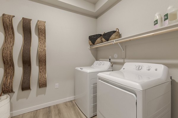 Laundry room with modern appliances in Overture Andalucia Apartments, ideal for a convenient living experience in a luxury Greystar community