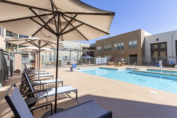 Resort-style swimming pool at Overture Andalucia Apartments offering luxury relaxation amenities