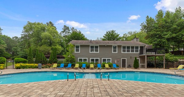 Relaxing pool area at Somerset at the Crossings Apartments with sun loungers and landscaped surroundings