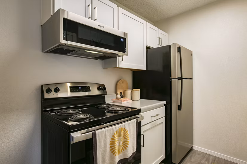 Sleek modern kitchen with stainless steel appliances and island at Aydan Apartments, a luxury living space designed for comfort and style