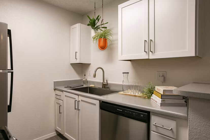 Modern kitchen featuring sleek countertops and stainless steel appliances in Aydan Apartments, a luxury living community