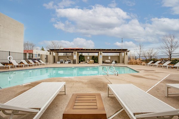 Resort-style pool with lounge chairs at Aydan Apartments, offering luxury living in prime location
