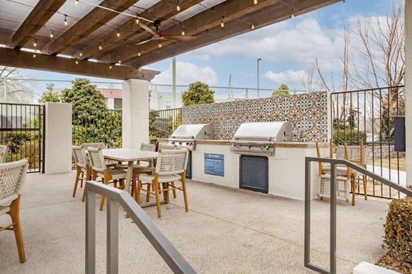 Outdoor patio with modern grill area at Aydan Apartments, offering luxury living spaces