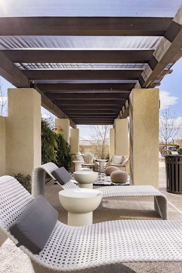 Patio with outdoor seating and lush greenery at Aydan Apartments, Greystar luxury community