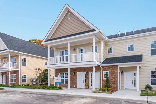 Modern bedroom with plush furnishings at Vistas of Port Jefferson Apartments