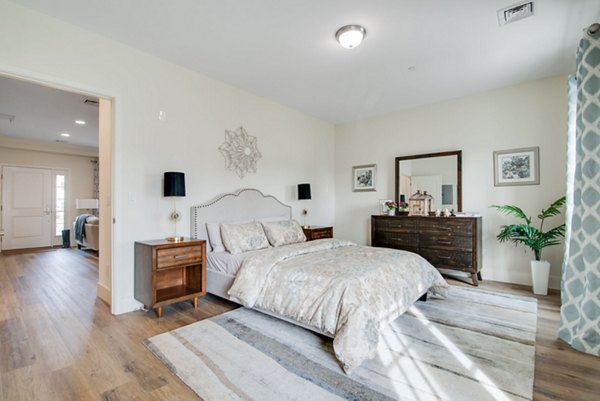 Cozy bedroom with modern decor at Vistas of Port Jefferson Apartments