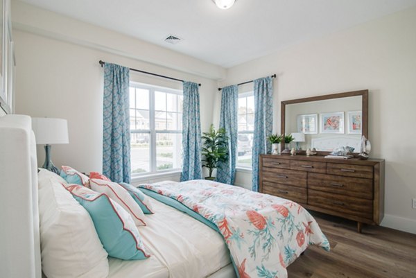 Cozy bedroom with elegant furnishings at Vistas of Port Jefferson Apartments