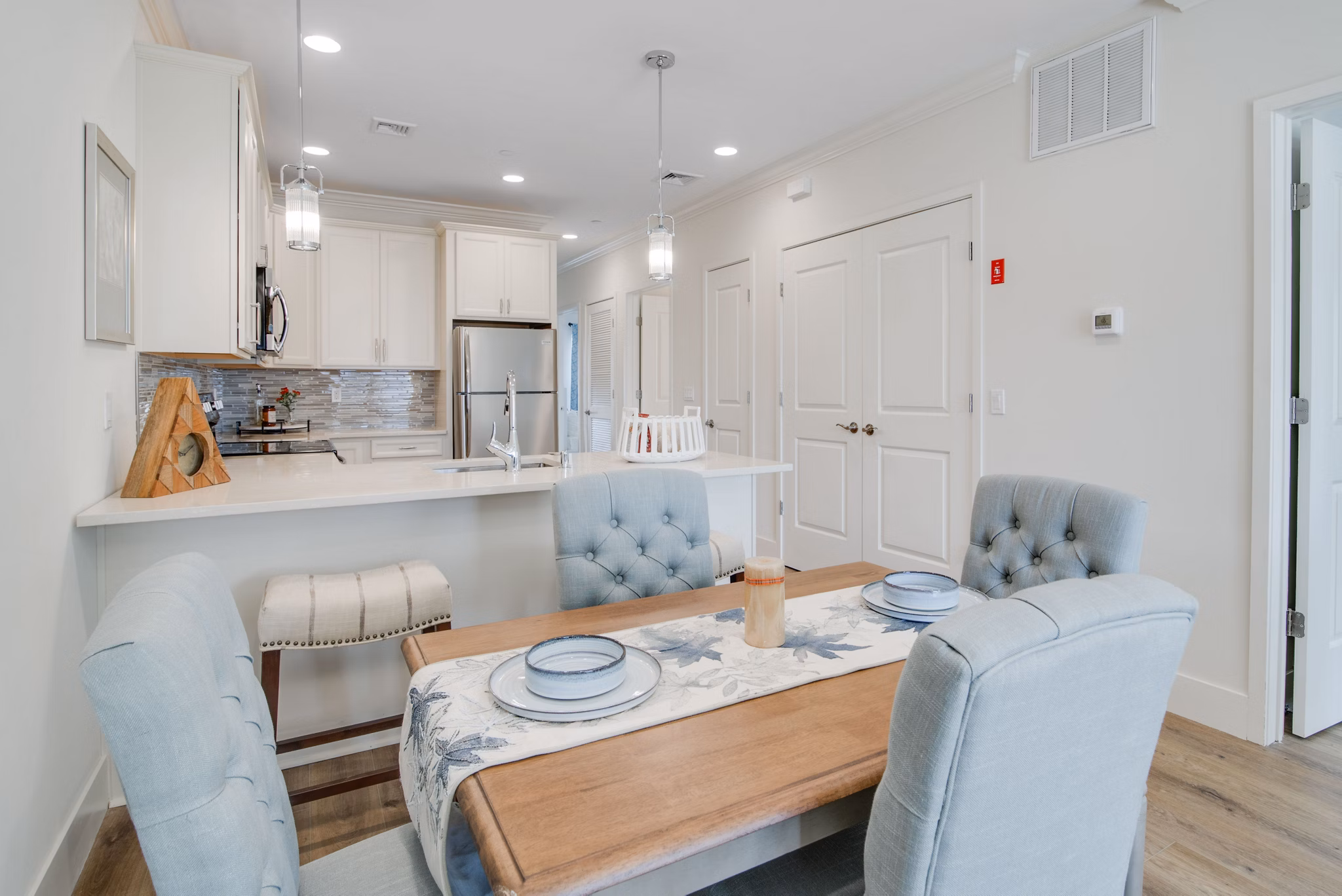 Dining area with modern decor at Vistas of Port Jefferson Apartments, featuring elegant lighting and ample seating for luxury living