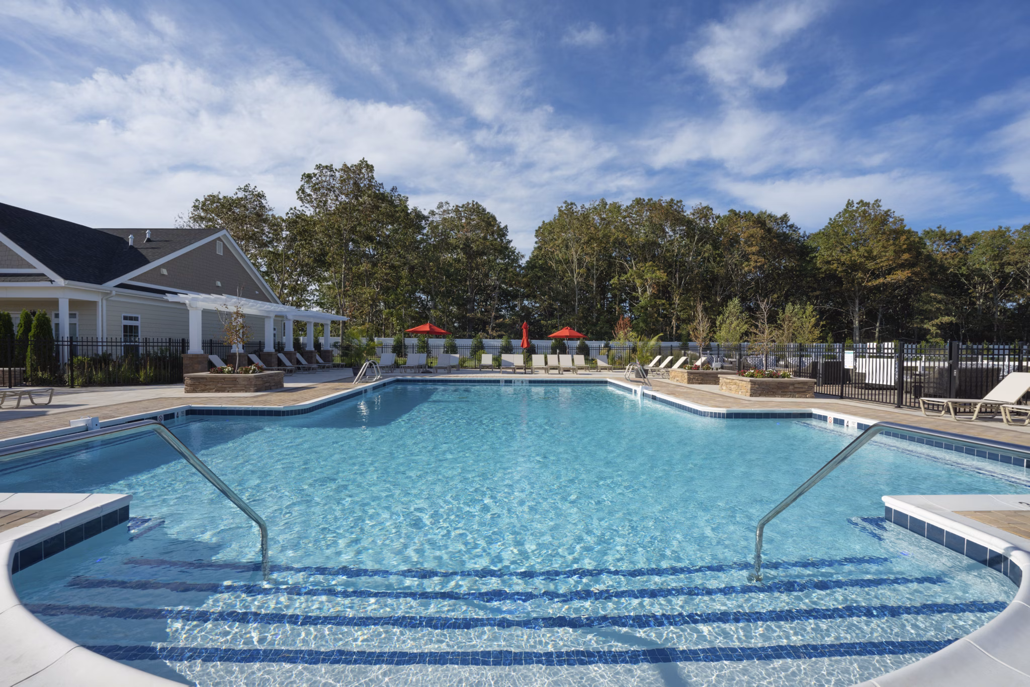 Inviting outdoor pool area at Vistas of Port Jefferson Apartments