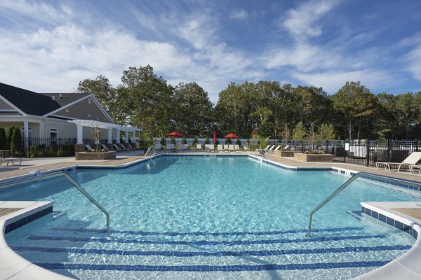 Inviting outdoor pool area at Vistas of Port Jefferson Apartments