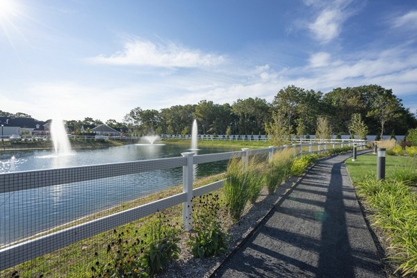 Courtyard with seating and lush landscaping at Vistas of Port Jefferson Apartments