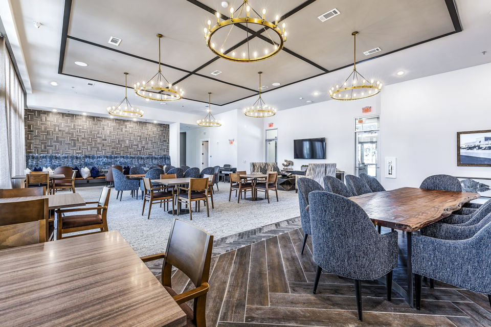 Clubhouse dining room with elegant lighting and spacious seating at Album Mansfield Apartments