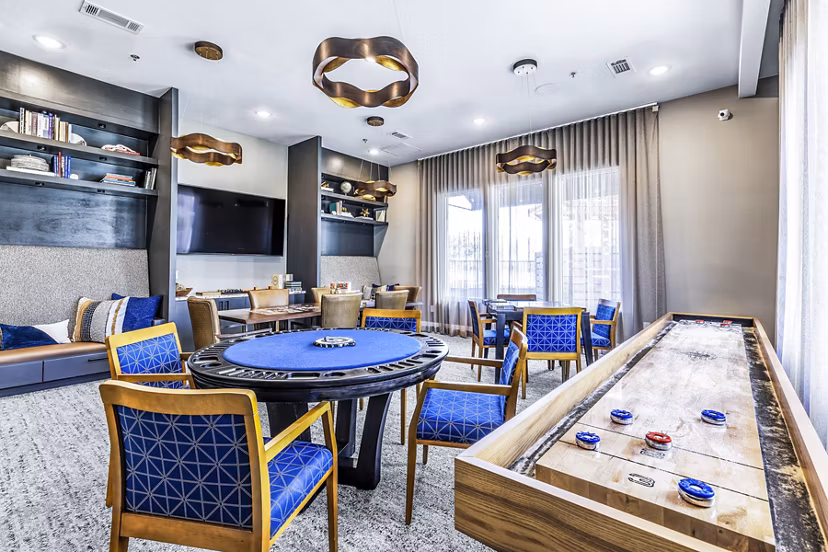 Luxury clubhouse game room with billiards in Album Mansfield Apartments, offering a vibrant social space for residents
