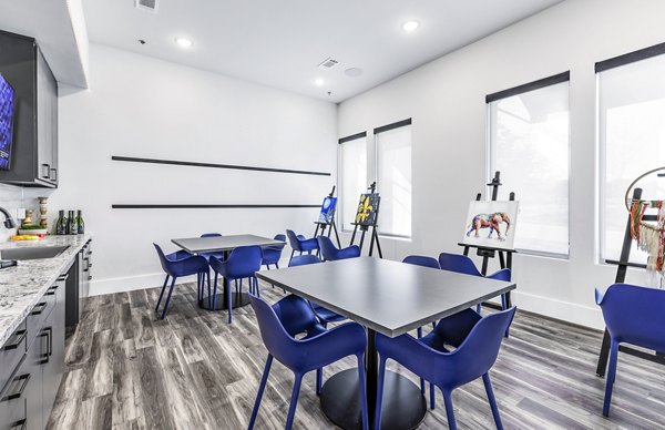 Bright and creative clubhouse art room at Album Mansfield Apartments, with ample workspace and colorful decor for resident activities