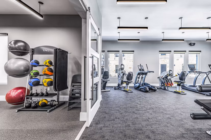 State-of-the-art fitness center at Album Mansfield Apartments with modern workout equipment