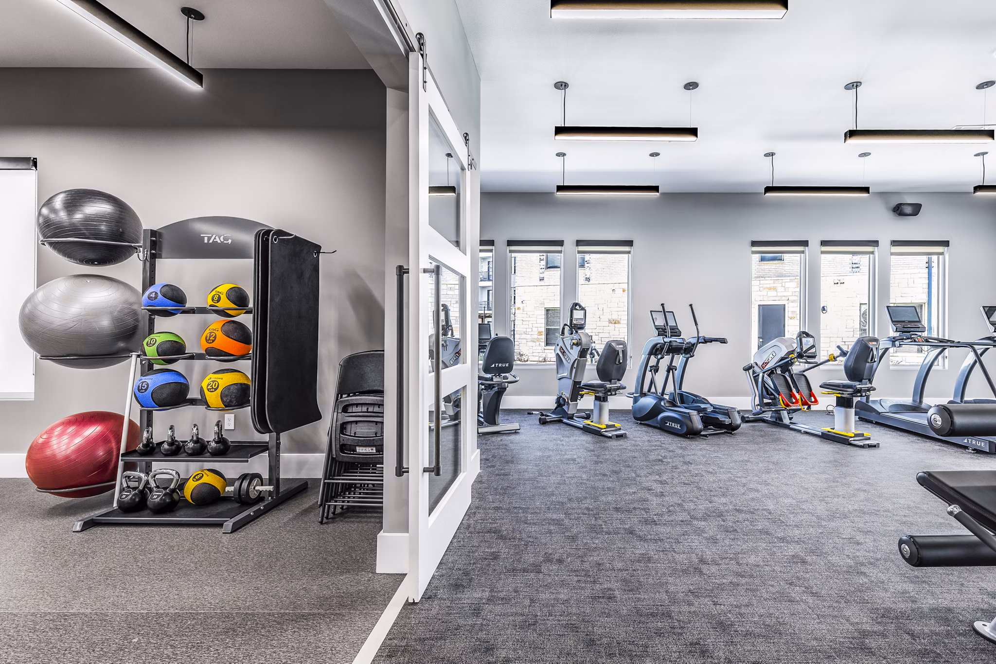 State-of-the-art fitness center at Album Mansfield Apartments with modern workout equipment