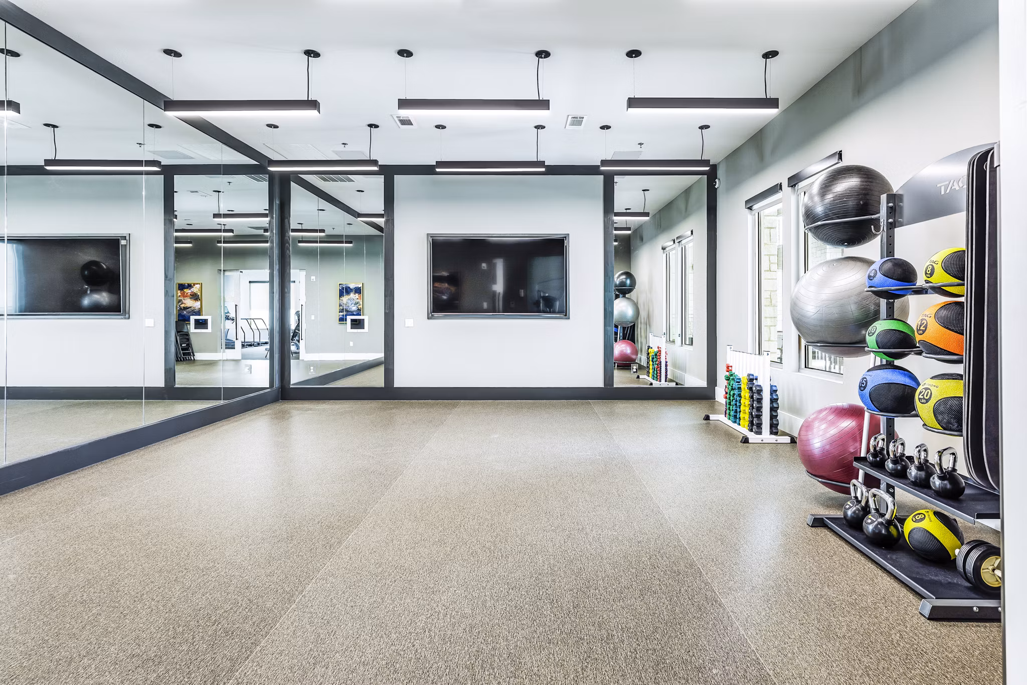 Modern fitness center with state-of-the-art equipment at Album Mansfield Apartments, promoting active lifestyle and wellness
