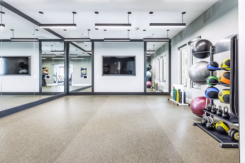 Modern fitness center with state-of-the-art equipment at Album Mansfield Apartments, promoting active lifestyle and wellness