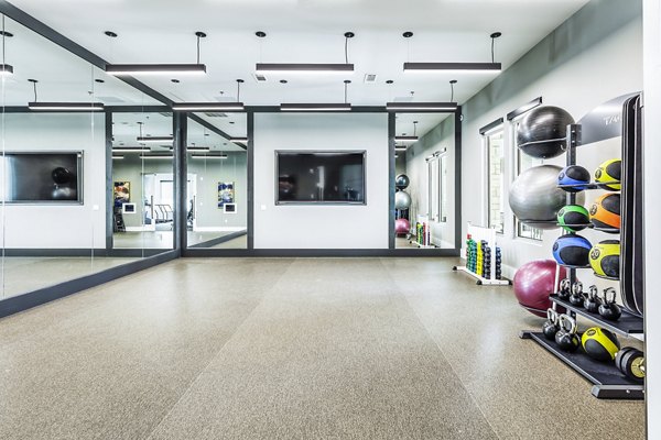 Modern fitness center with state-of-the-art equipment at Album Mansfield Apartments, promoting active lifestyle and wellness