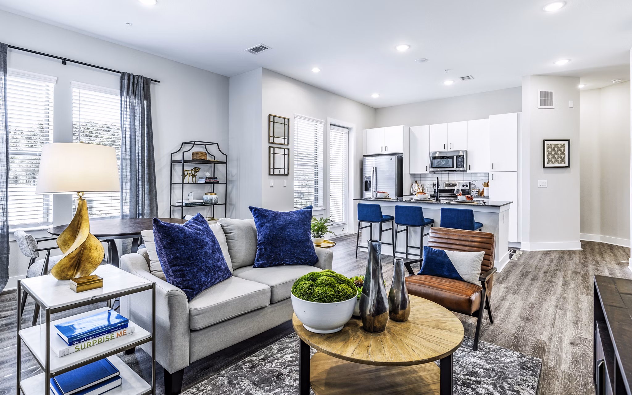 Cozy living room with plush seating and large windows in Album Mansfield Apartments