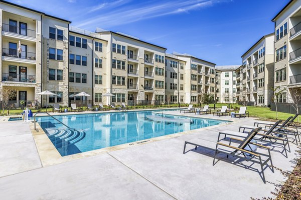Album Mansfield Apartments: Luxurious pool with poolside loungers and landscaped surroundings at a Greystar property
