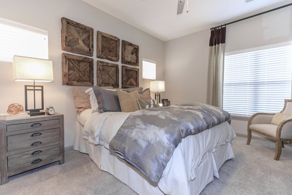 Cozy bedroom with modern decor at The Lodges on English Station Rd Apartments