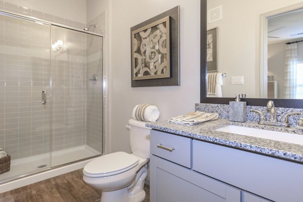Modern bathroom with sleek fixtures at The Lodges on English Station Rd Apartments