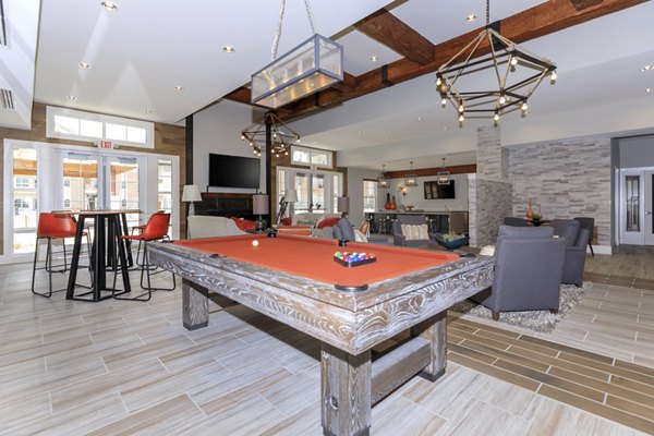 Clubhouse featuring stylish lounge and bar area at The Lodges on English Station Rd Apartments