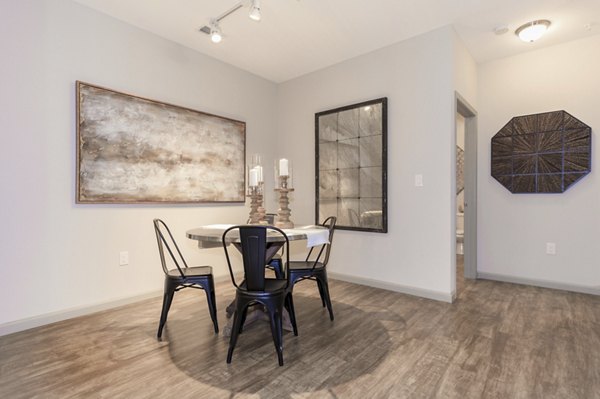 Dining area with modern furnishings and natural lighting at The Lodges on English Station Rd Apartments