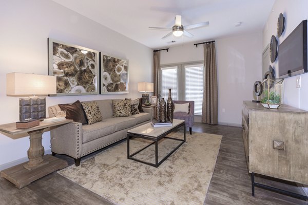 Cozy living room with modern furnishings at The Lodges on English Station Rd Apartments